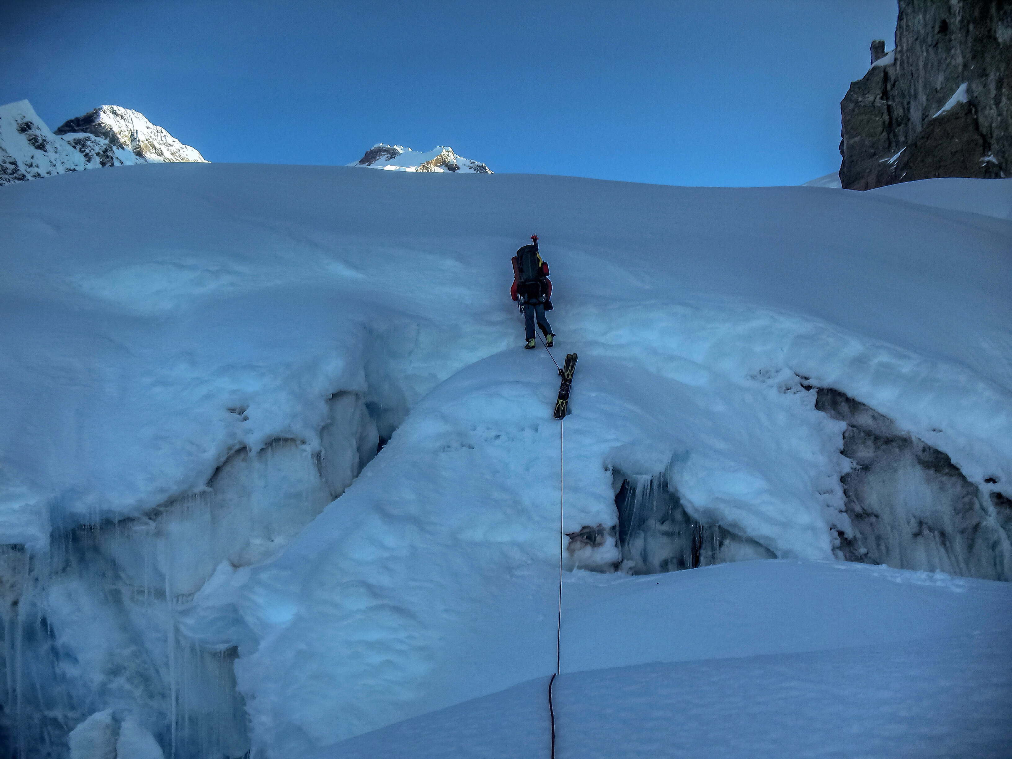 Glacier approach to Mount Logan base camp with sleds and climbers visible on snowfield