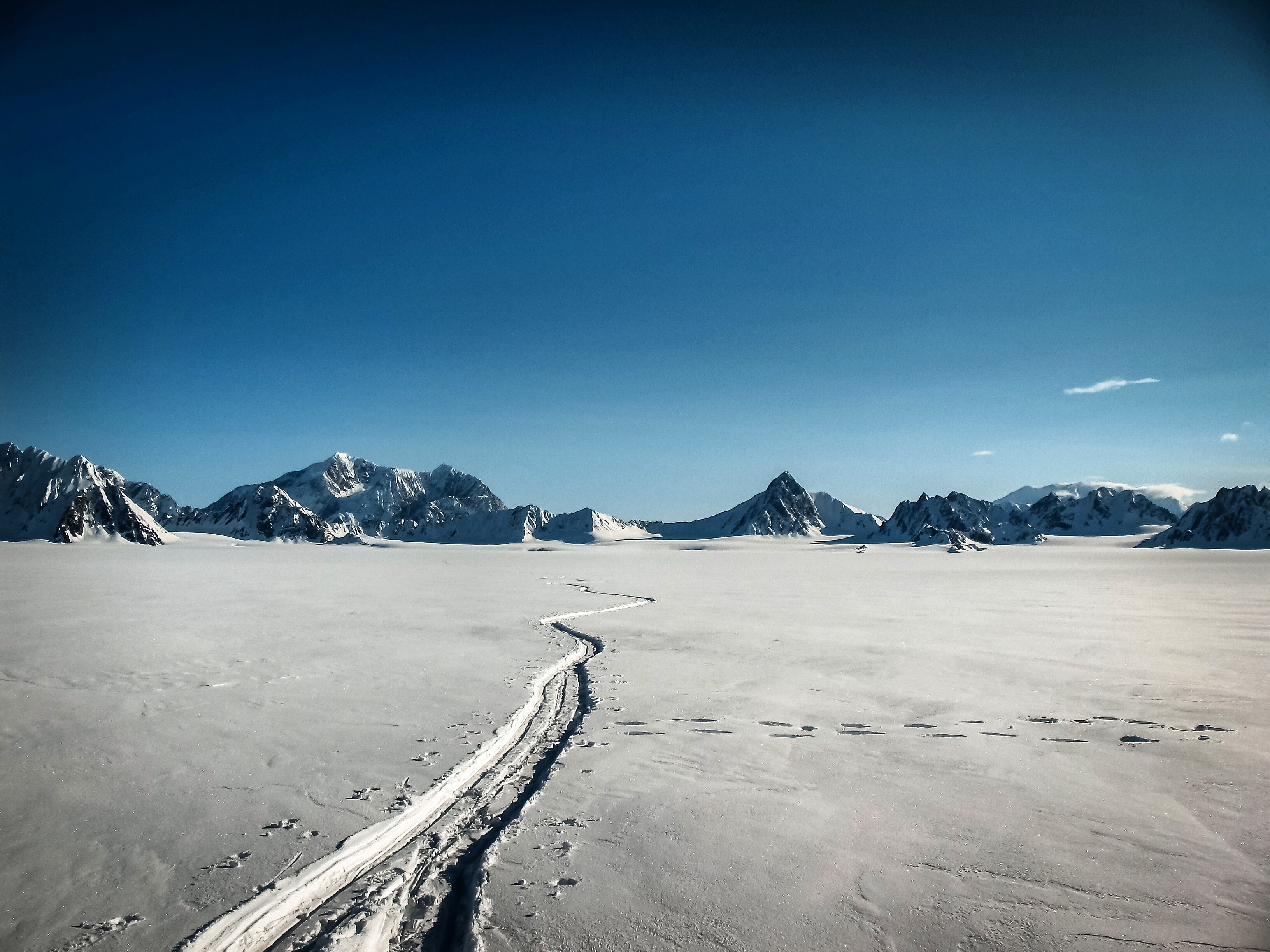 High camp on Mount Logan with distant peaks of the Saint Elias Range visible